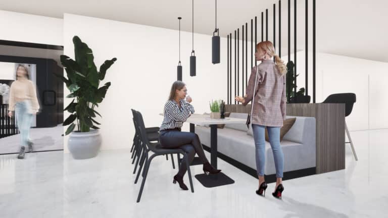 Lounasravintolan loossipöydän ääressä istuu nainen juomassa kahvia. Vaaleassa sisustuksessa on käytetty marmoria, puuta ja viherkasveja.